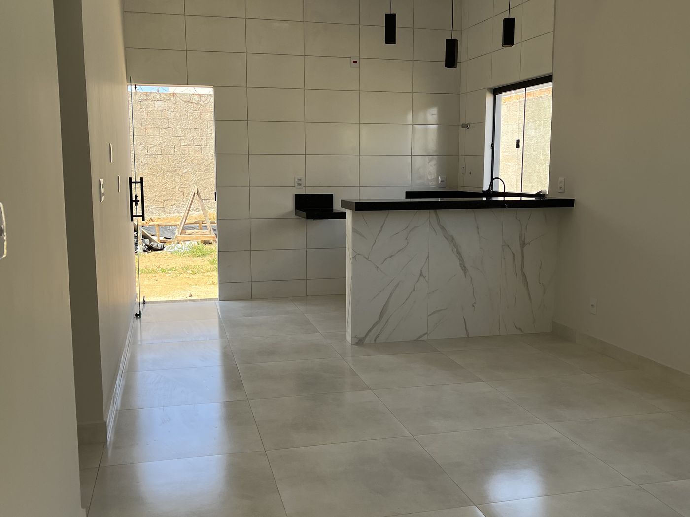 Cozinha acabada com bancada e porcelanato em casa da Masta